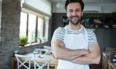 portrait smiling owner standing bakery shop 1170 2075